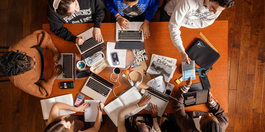 Group of students collaborating around a table.